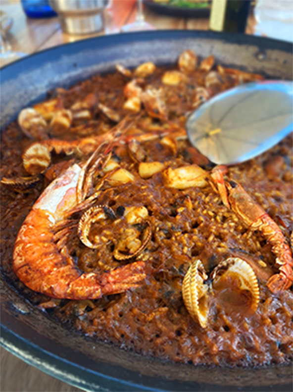 Paella is a Spanish dish. It contains rice, shrimp, and clams.