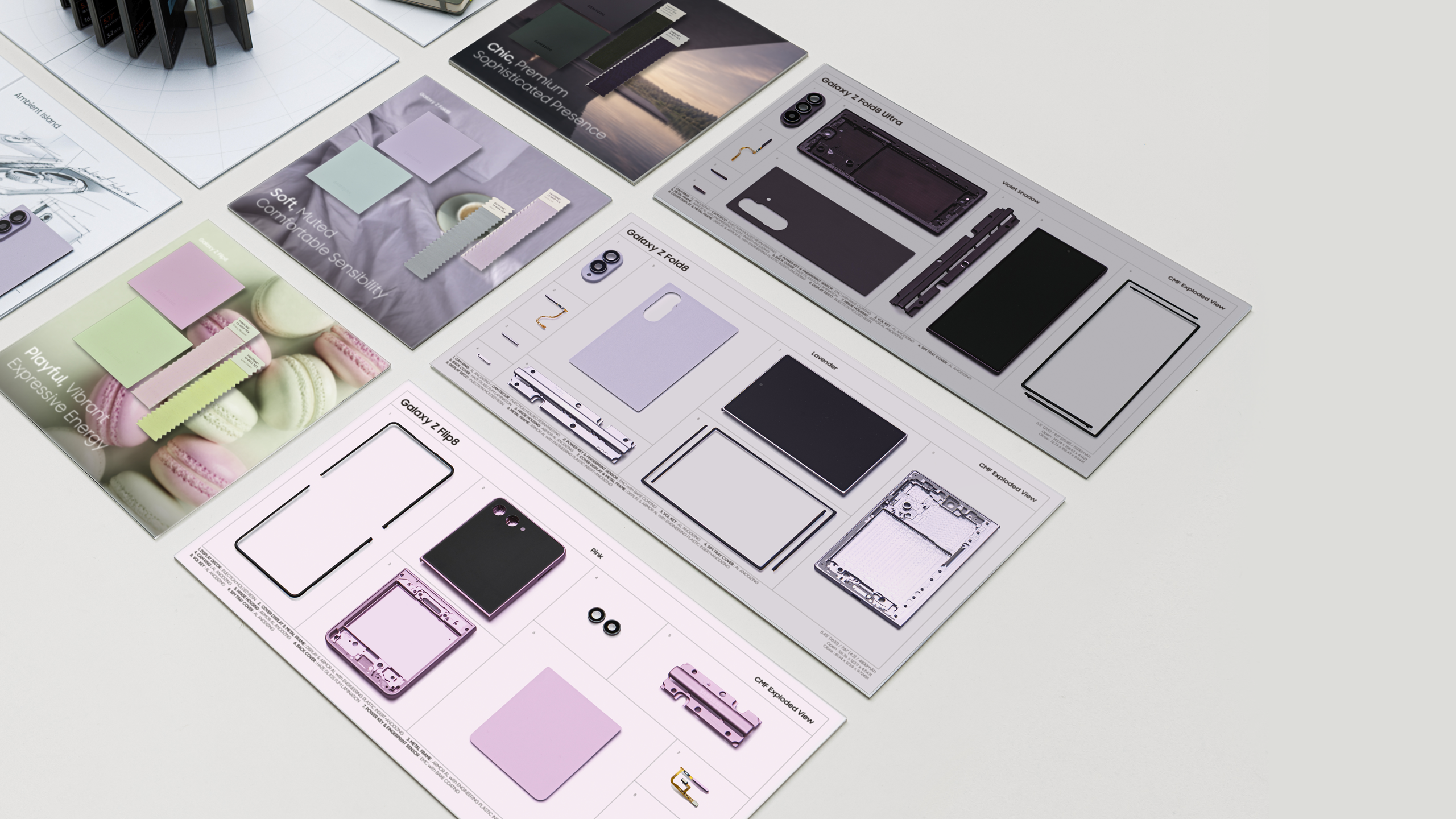 Product design development materials for Samsung Galaxy Z Fold displayed on a white surface. On the left are marketing images featuring pink, mint green, and lavender macarons with color palettes, along with a pink model phone and internal structure diagrams. On the right are technical specification sheets for the Galaxy Z Fold9, showing multiple design options in black, white, and purple colors with detailed hardware components including camera module, display, and hinge mechanism layouts across several documentation pages.