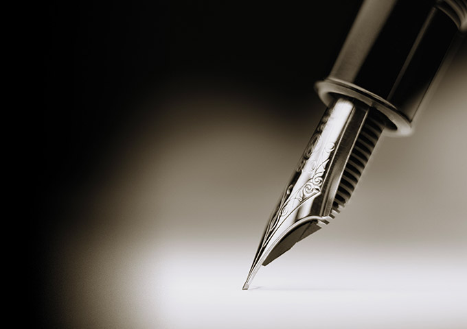 A fountain pen is placed on paper.