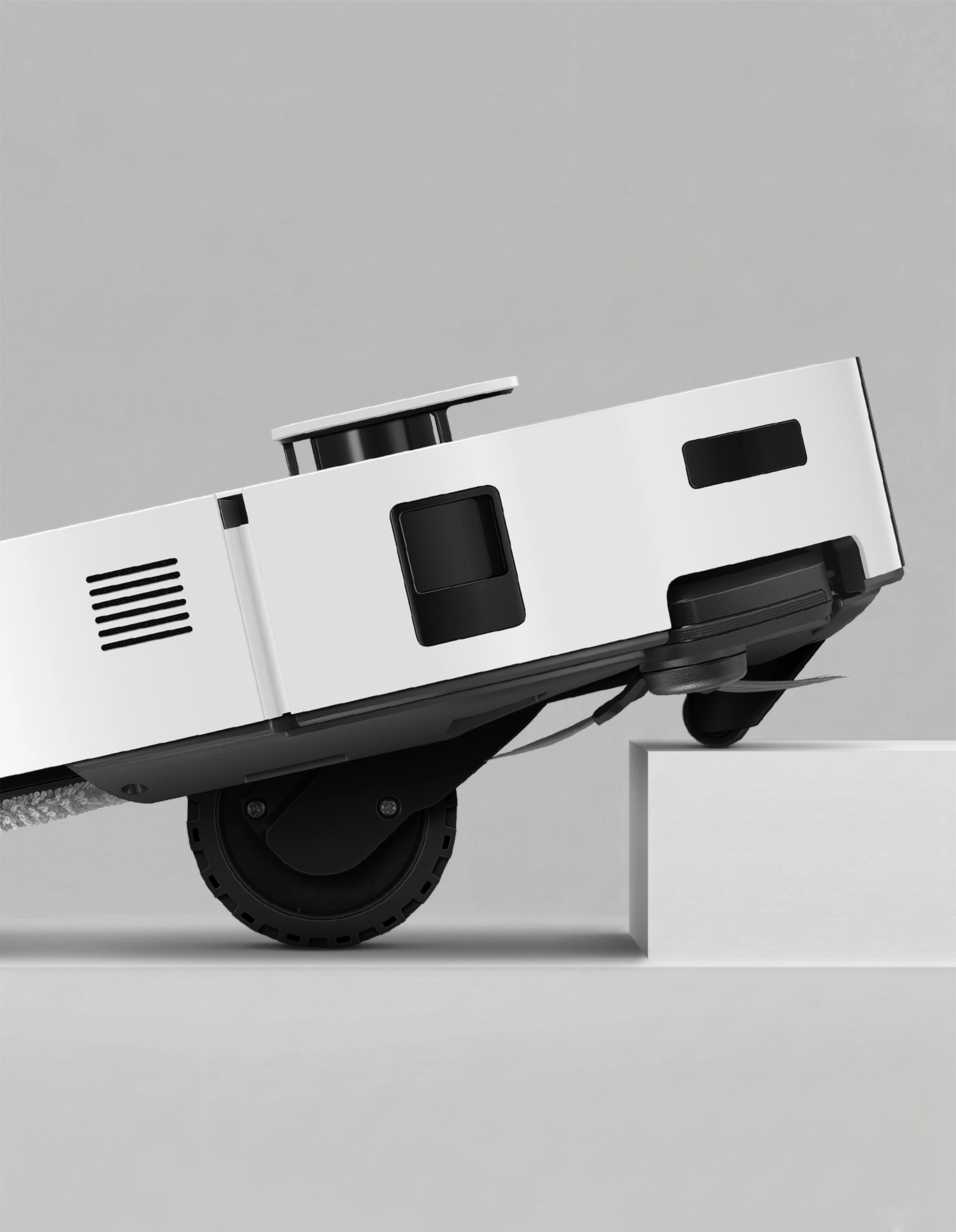 Bespoke AI Steam Ultra climbing over a threshold with its front caster wheel and rear main wheels.