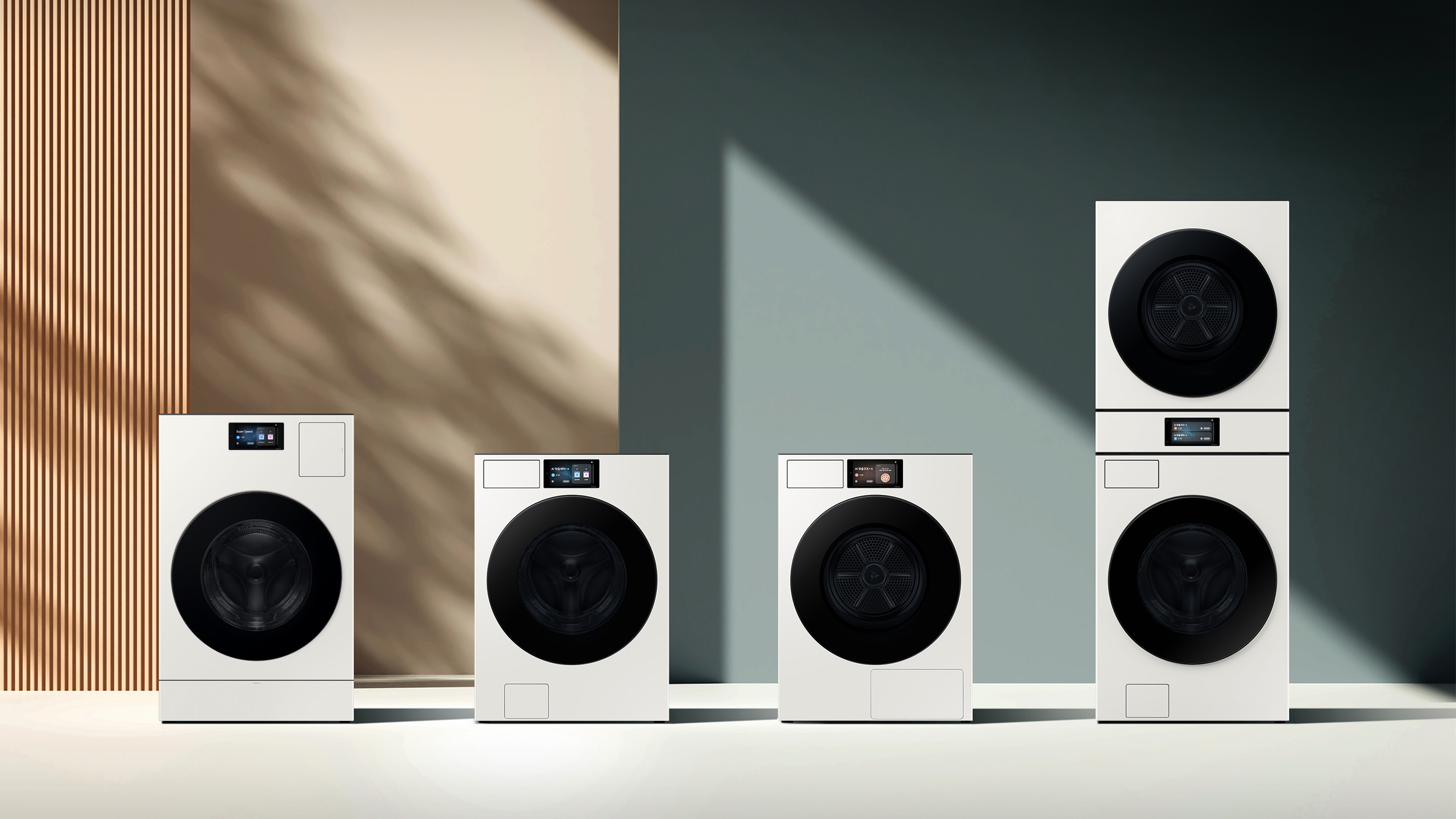 Various types of washing machines and dryers are placed side by side in a sunlit space.