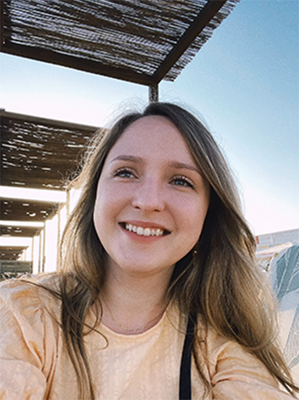 A selfie of a young white woman on the beach in Castelldefels.