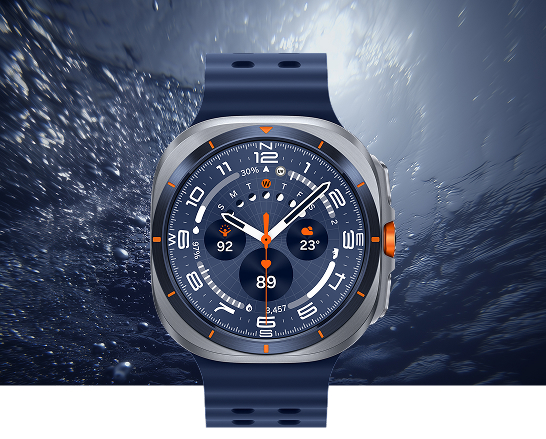 An image highlighting the Galaxy Watch 2025 Ultra model with a blue body and orange accents, set against a deep-sea background with rising air bubbles.