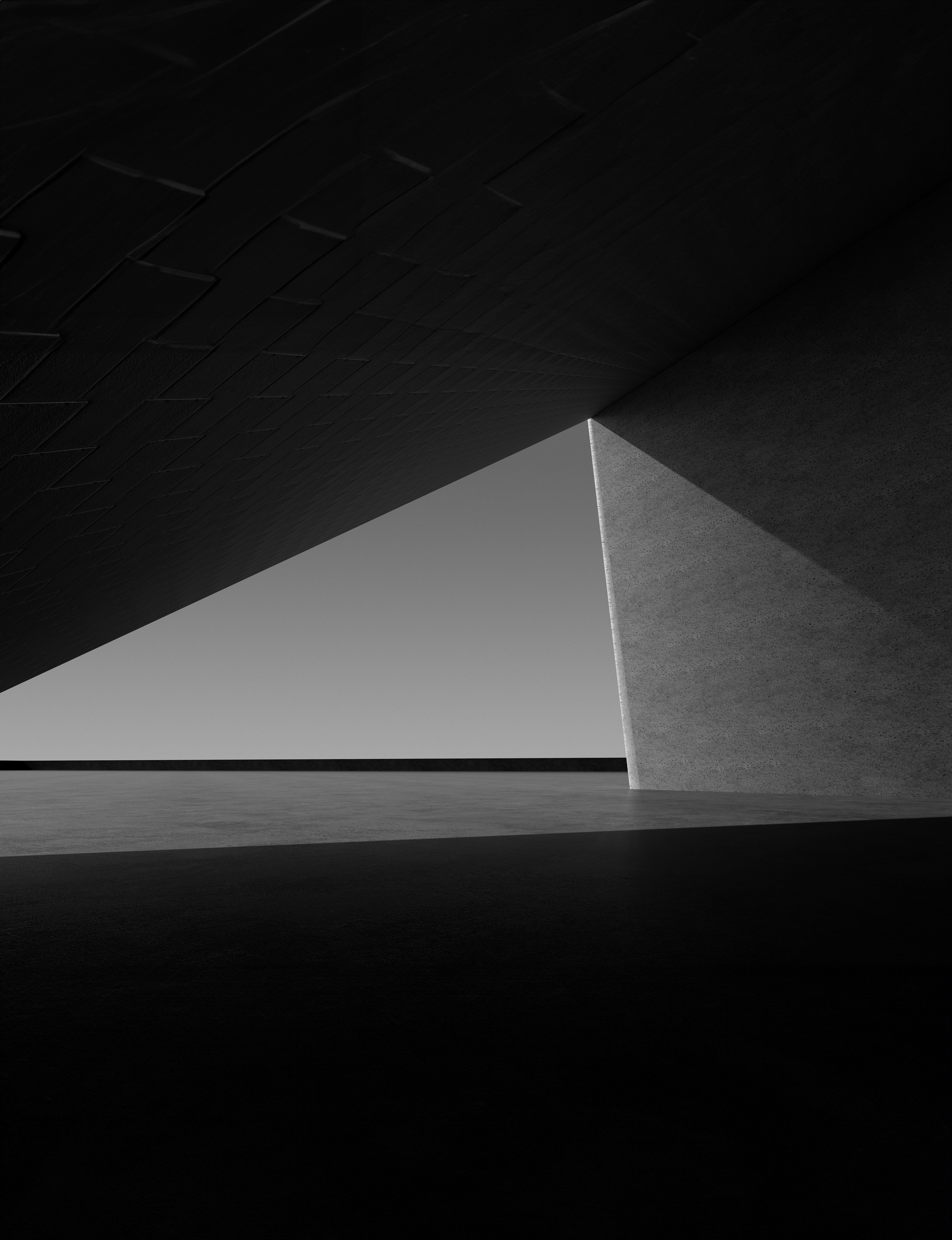 In black and white tones, the shadows cast by the slightly tilted walls and columns create a triangular composition.A space with geometric elements. 