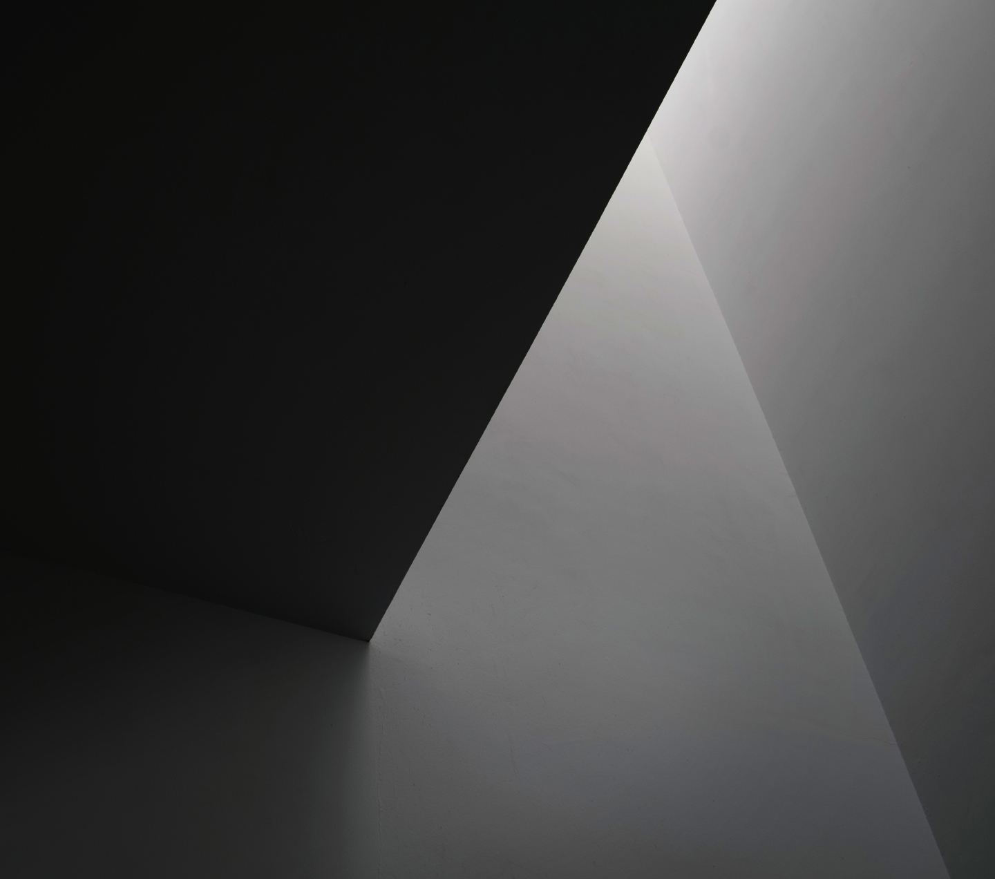 The Galaxy Z Fold 6 Silver Shadow standing facing the camera, with the Z Flip 6 Z Silver Shadow in front of it, opened at ninety degrees. The product background is a monotone, grayish image with sculptural details.