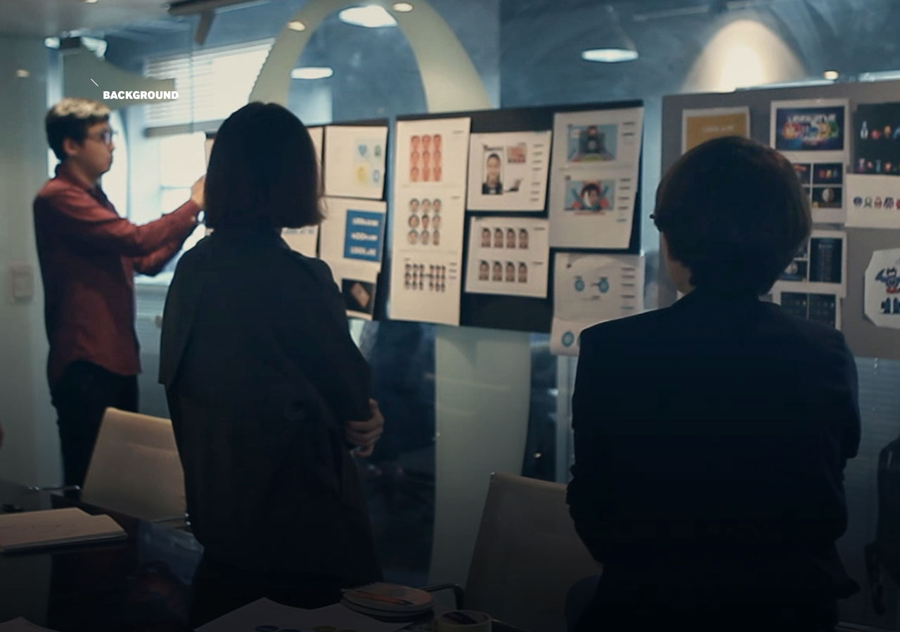 An image shows developers discussing images on a storyboard.