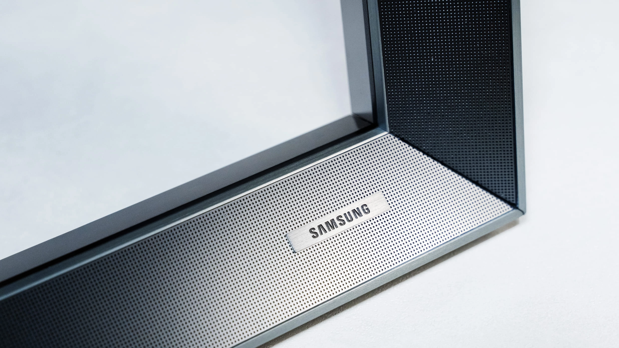 Transparent 130-inch Micro RGB display with refined steel frame details.