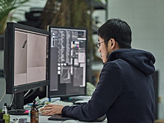 An image shows writer JaeYong Park immersed in his work.