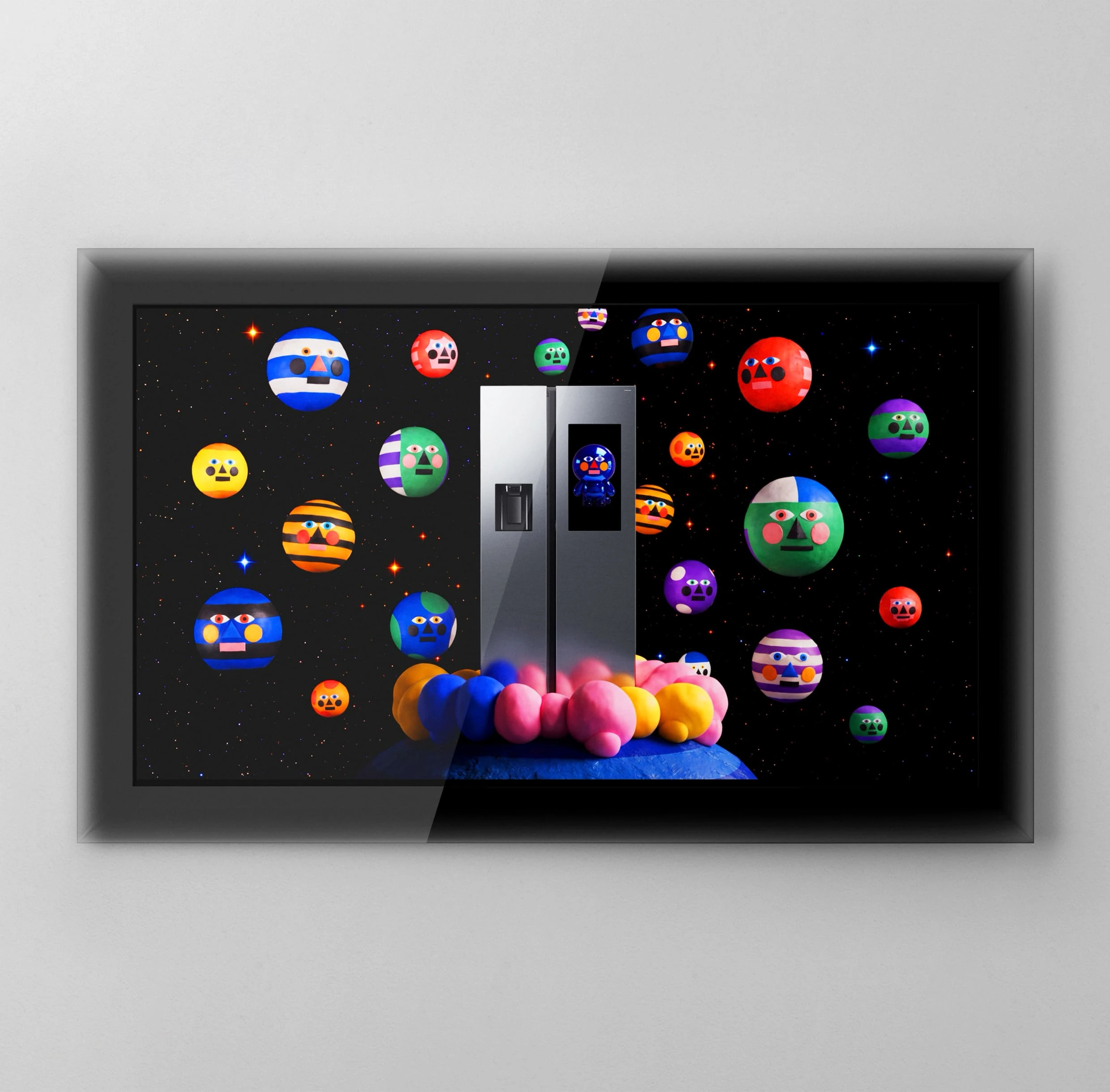 Inside a black and gray frame, a Bespoke AI Refrigerator Family Hub stands in a star-filled outer space scene. Colorful round planets with faces float around it, while a small character in a blue spacesuit appears on the refrigerator’s screen.