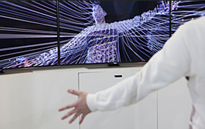 A visitor is experiencing Interactive Visualizing with Samsung Curved UHD TV – U9000s.